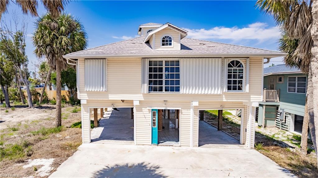 View of front of property featuring a carport