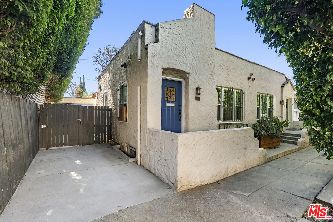 a view of a house with a wooden fence