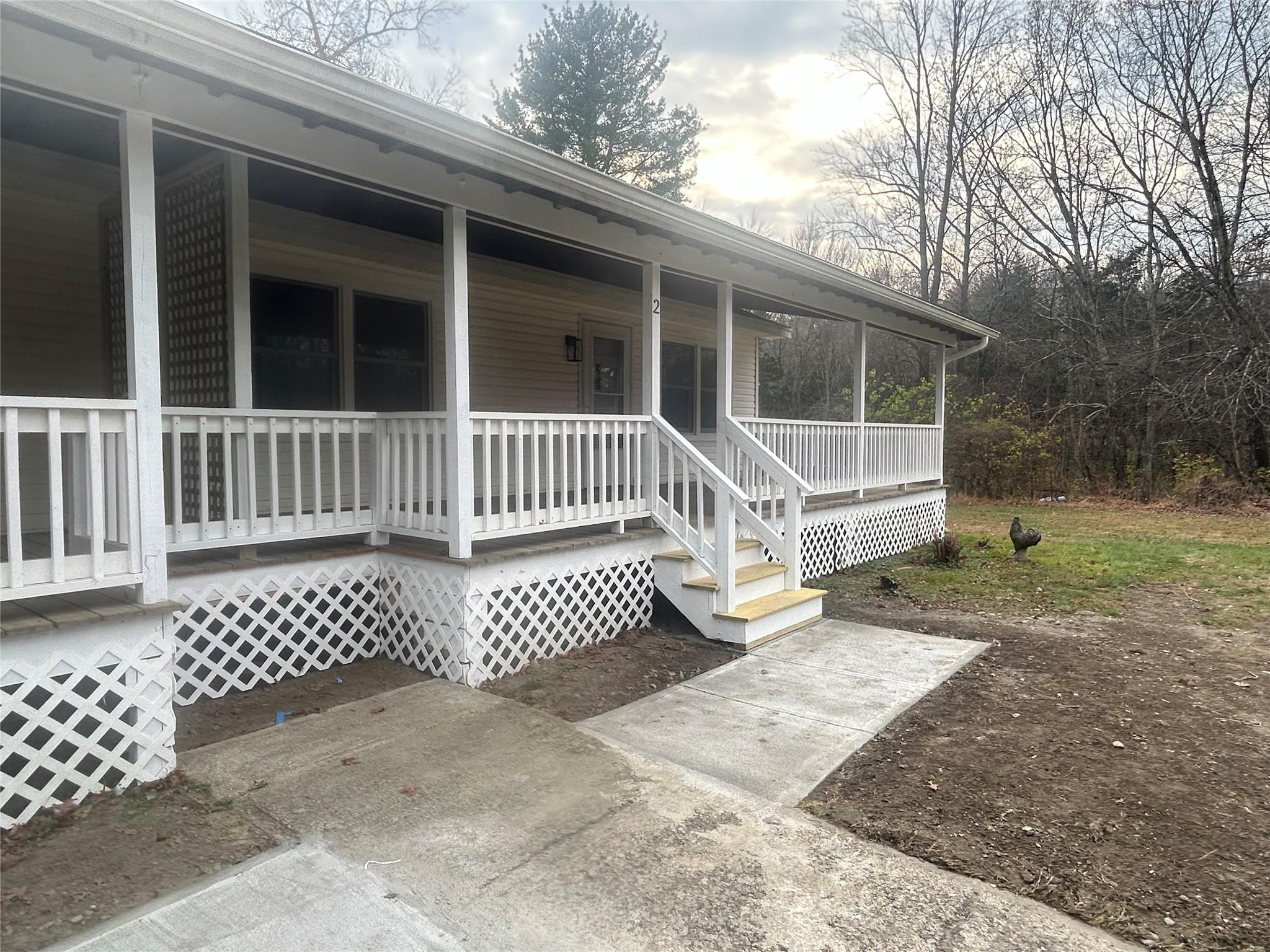 Doorway to property with covered porch