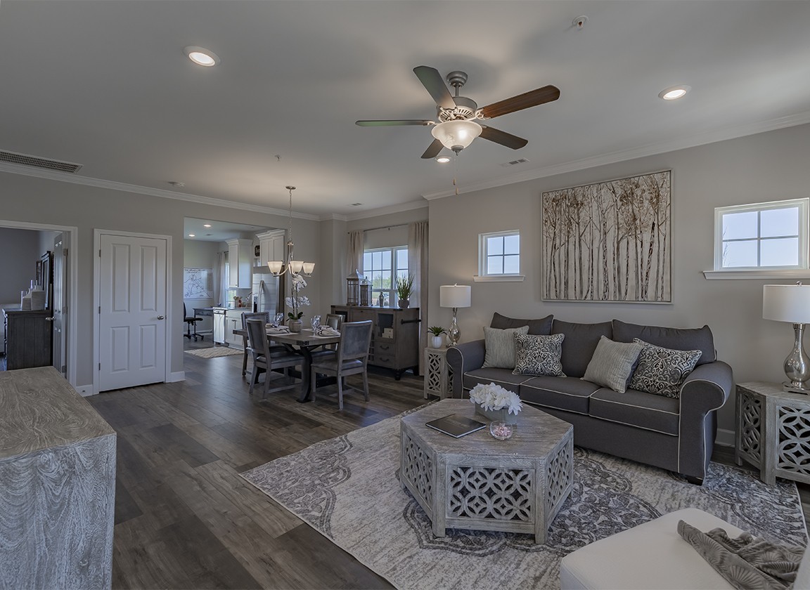 a living room with furniture and a dining table