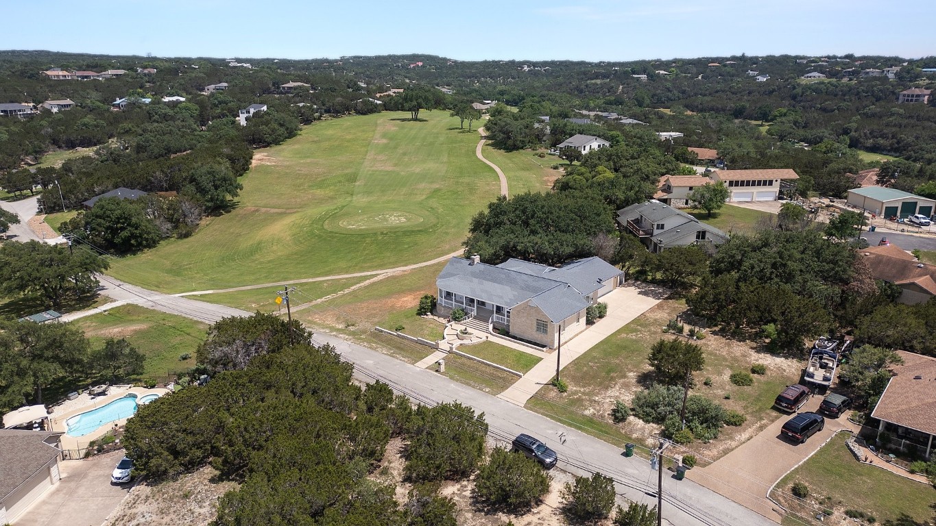 an aerial view of residential houses with outdoor space