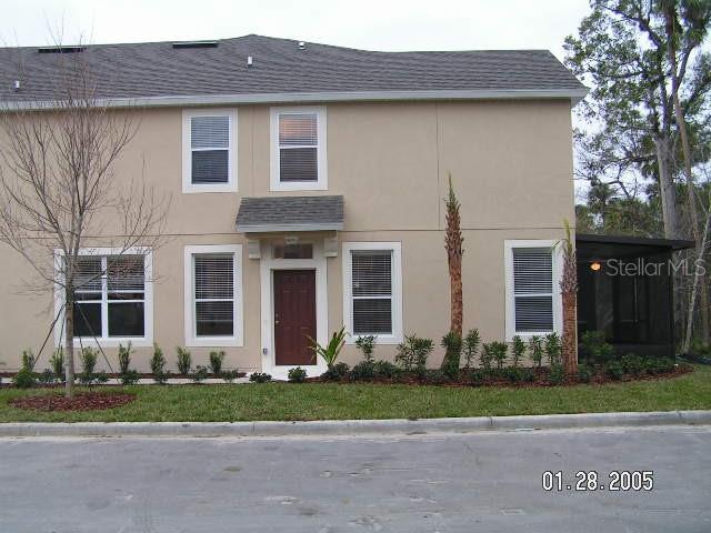 a front view of house with a garden