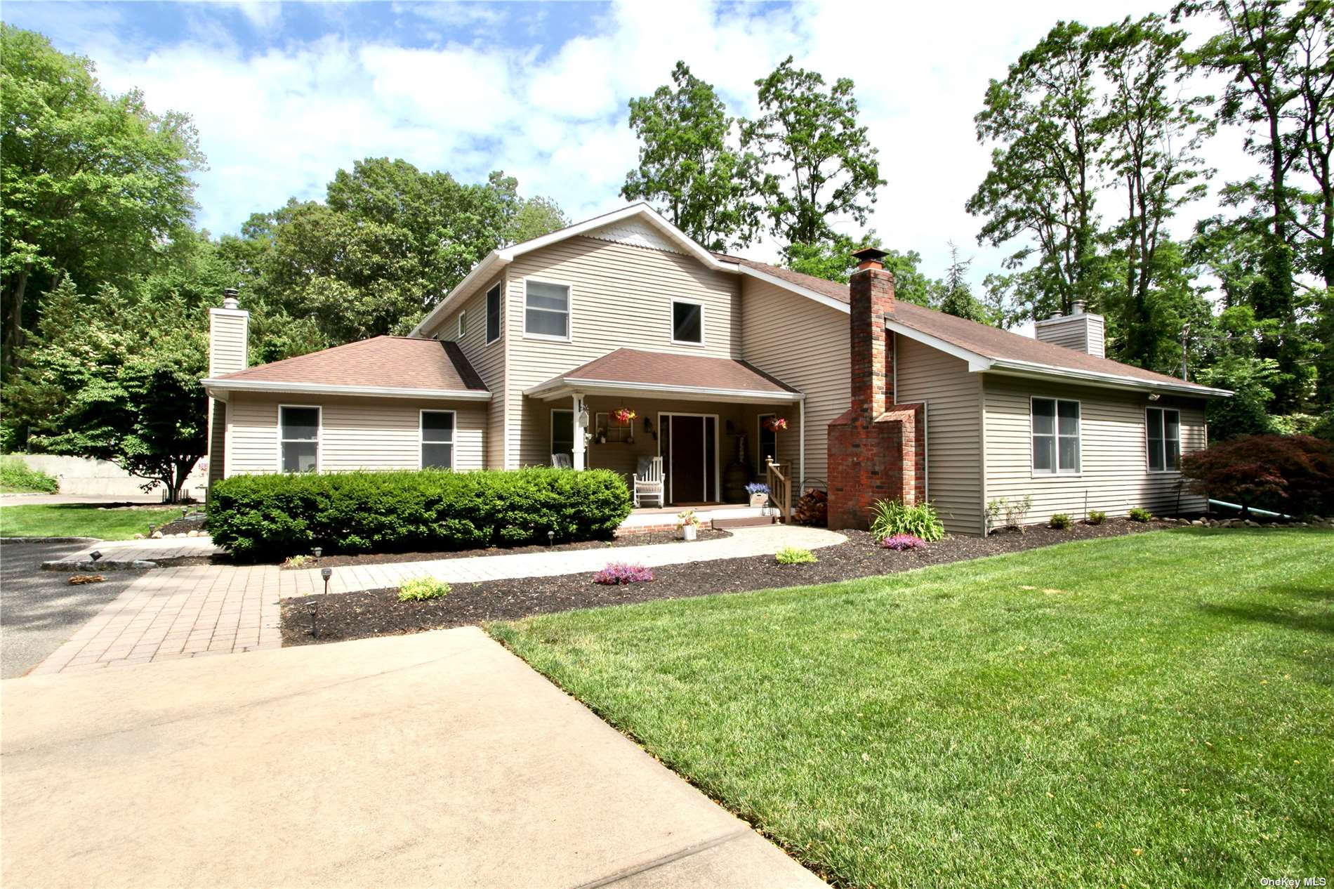 a front view of a house with a yard and porch