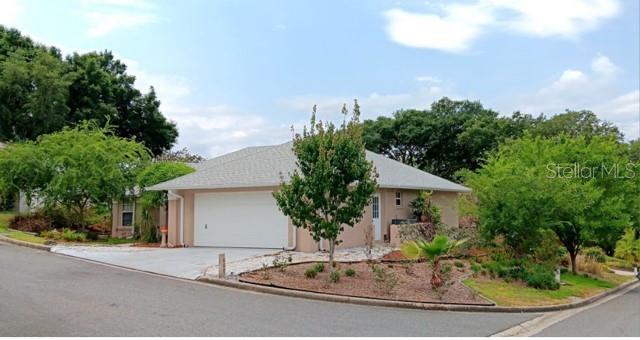 a front view of a house with garden and plants