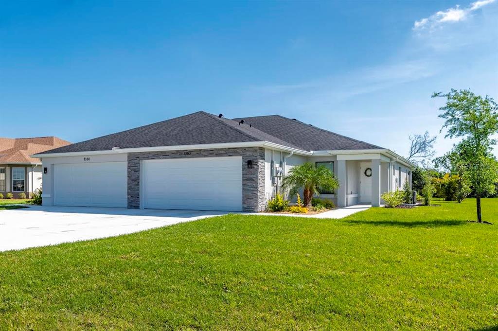 a front view of a house with a yard and garage