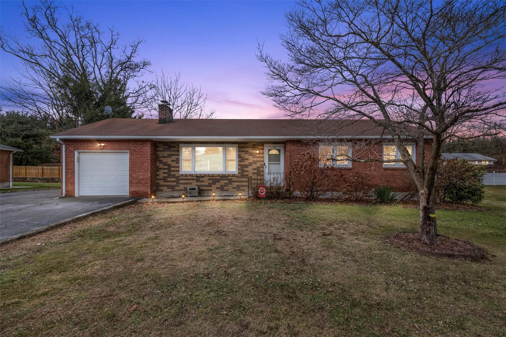 Ranch-style house with a yard and a garage