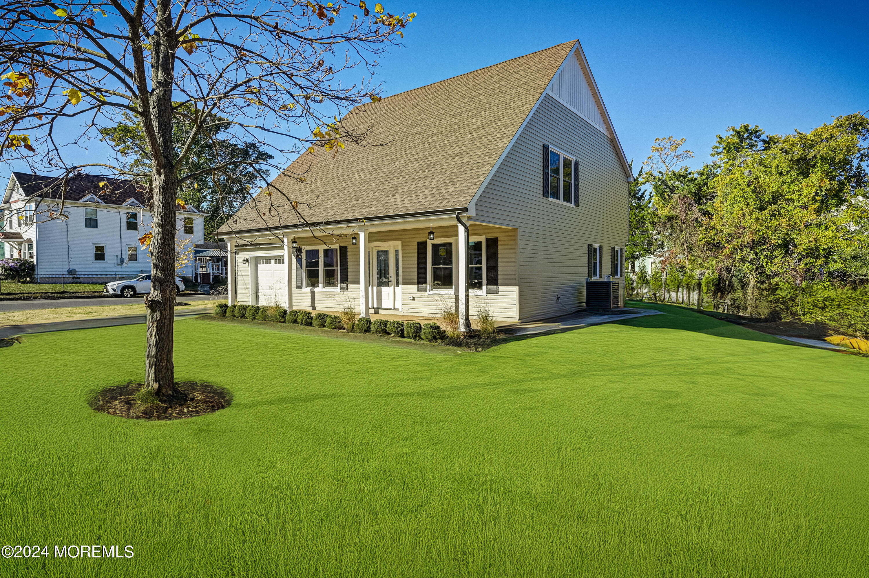 a front view of a house with a garden