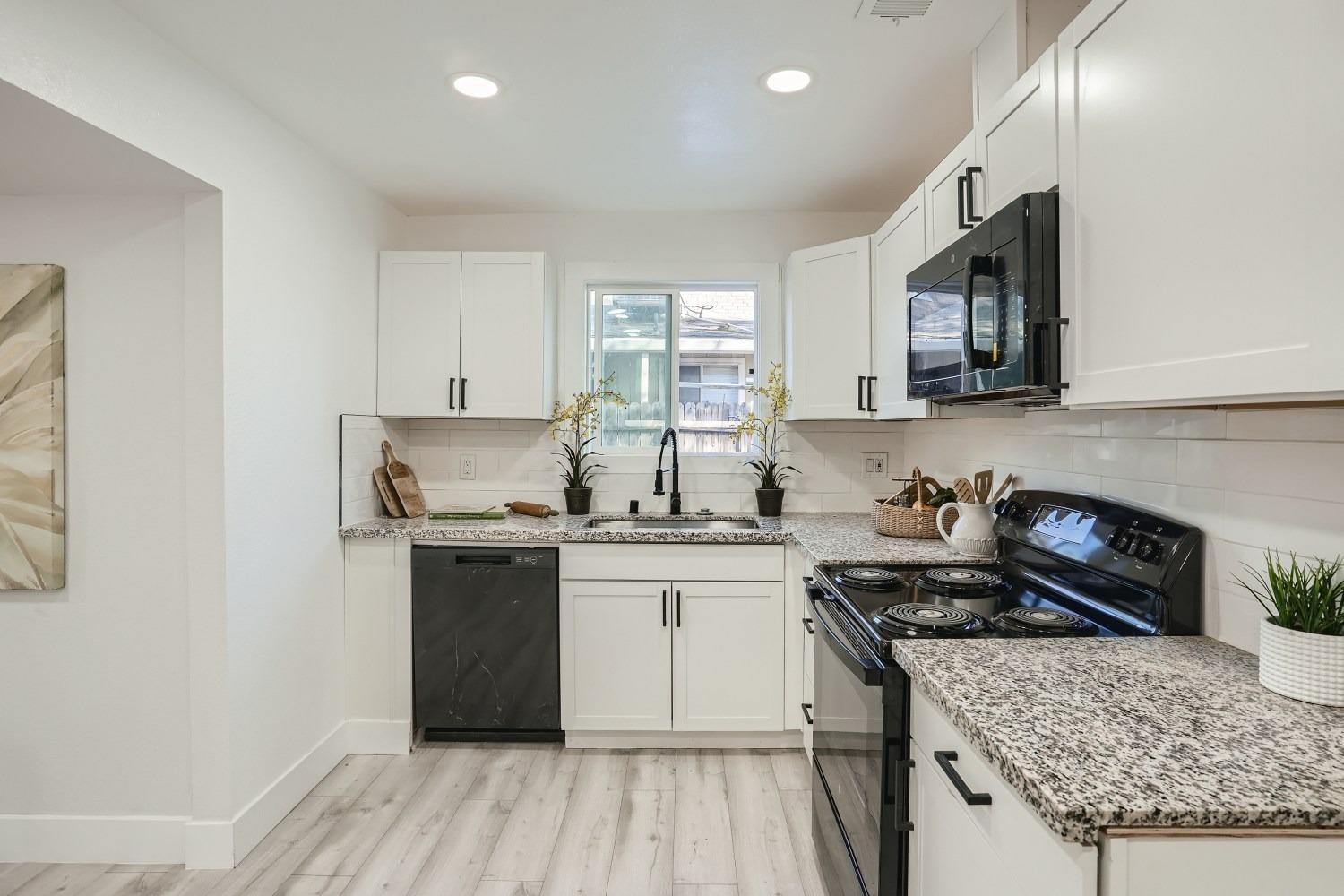 a kitchen with stainless steel appliances granite countertop a stove and a sink