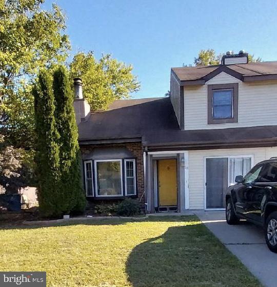 a view of a house with a swimming pool and a yard