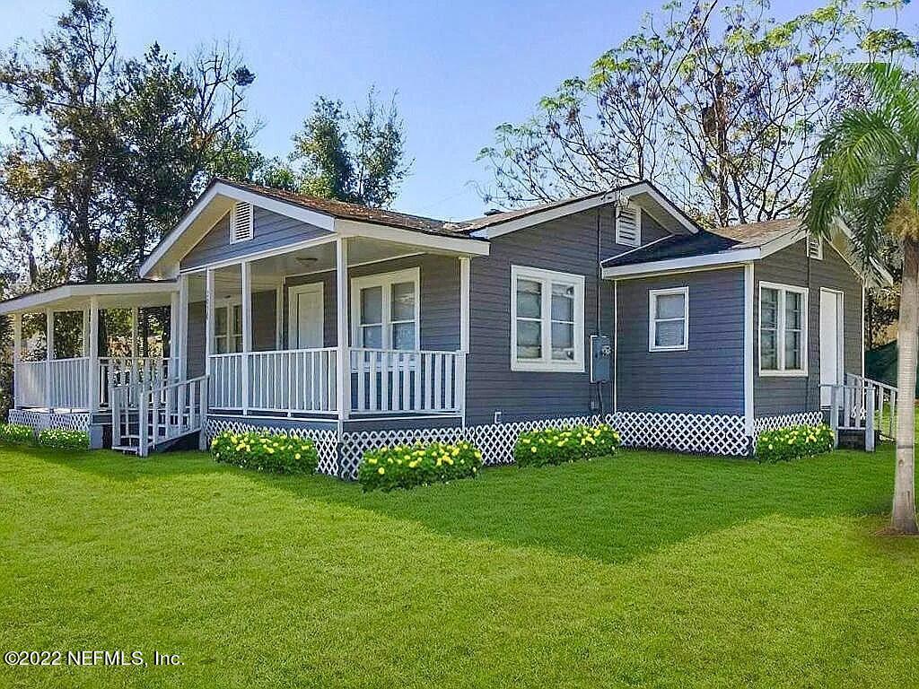 a view of a house with a yard and porch