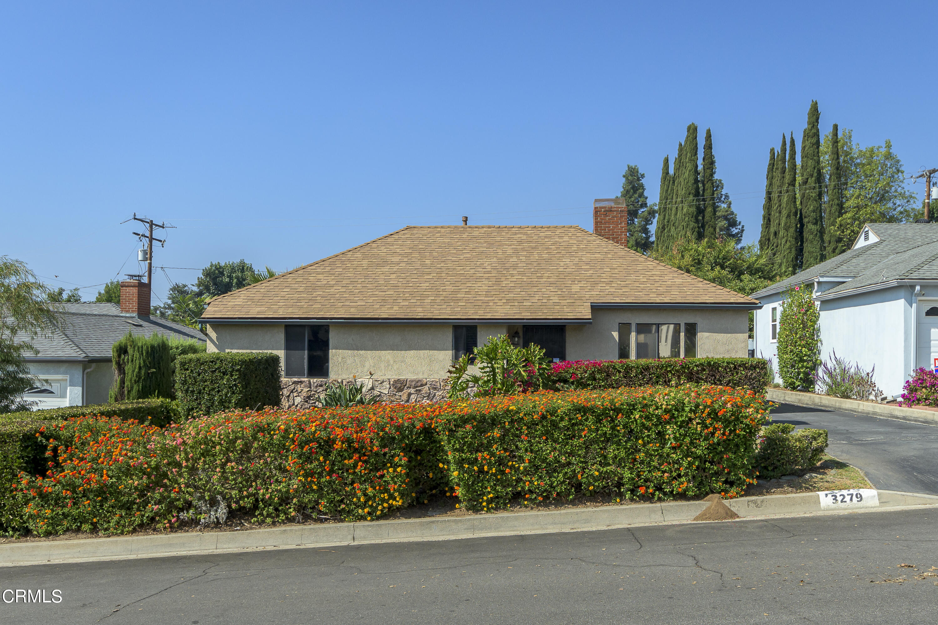 a front view of a house with a garden