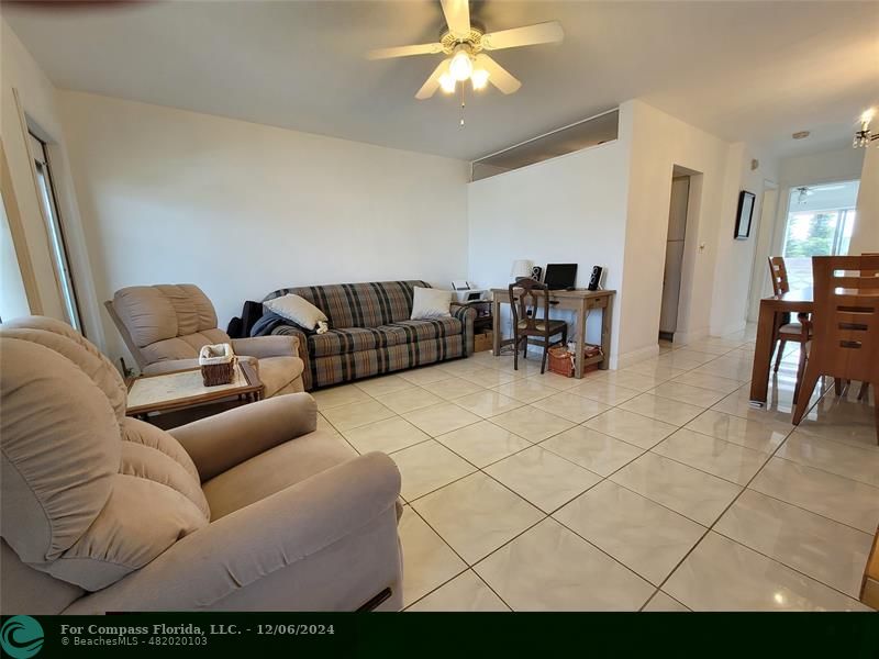 a living room with furniture and a dining table with projector