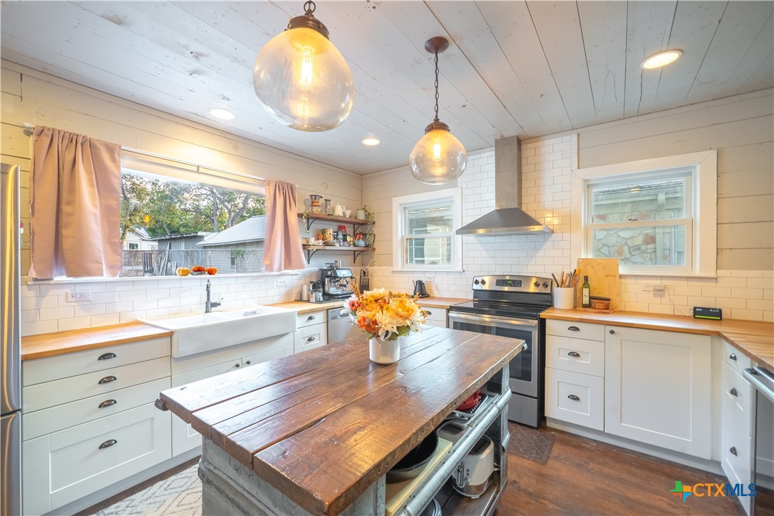 a kitchen with stainless steel appliances granite countertop a lot of counter space and a sink