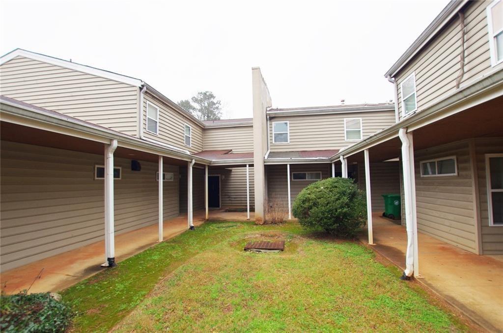 a view of a house with backyard and porch