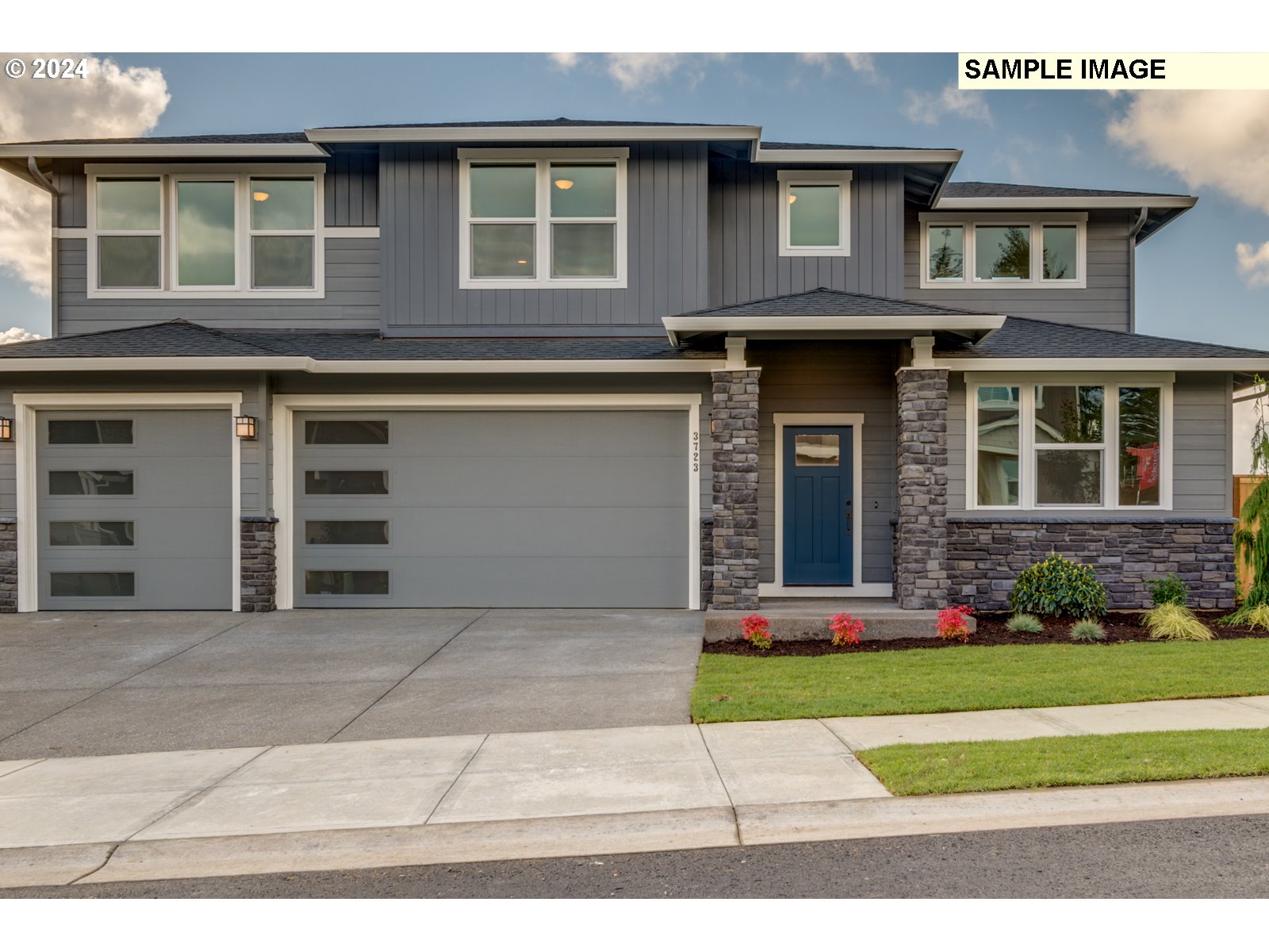 a front view of a house with a yard and garage