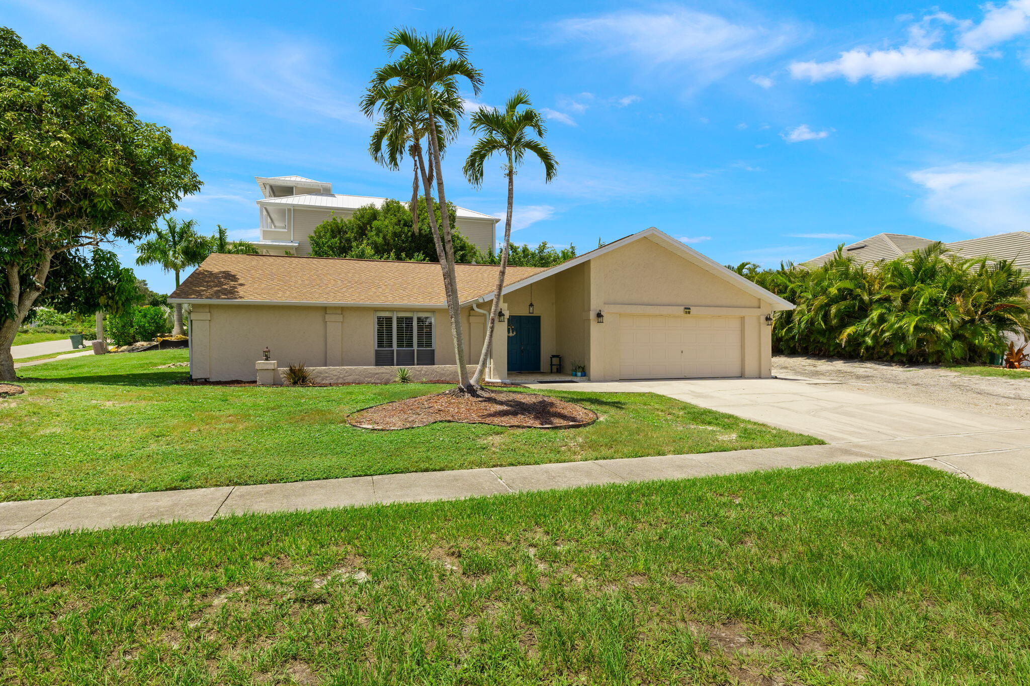 a front view of a house with a garden and yard