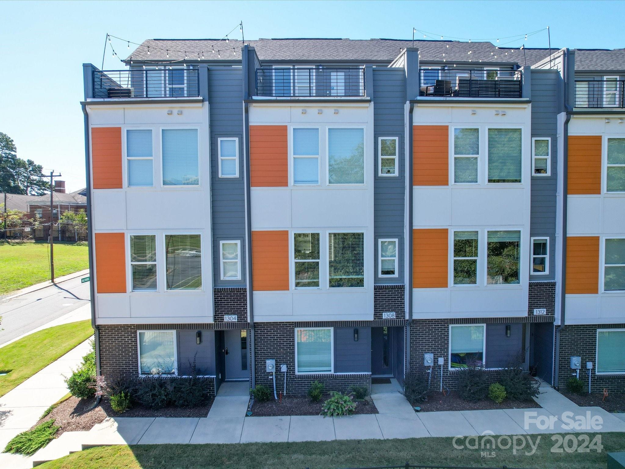 a front view of a residential apartment building with a yard