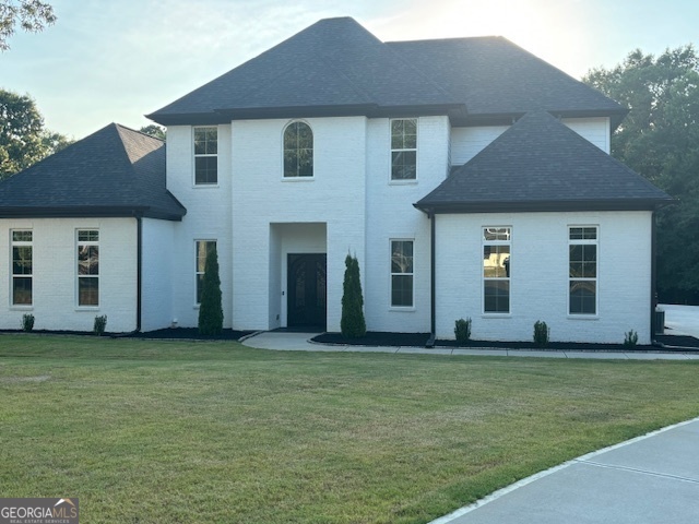 a front view of a house with a yard