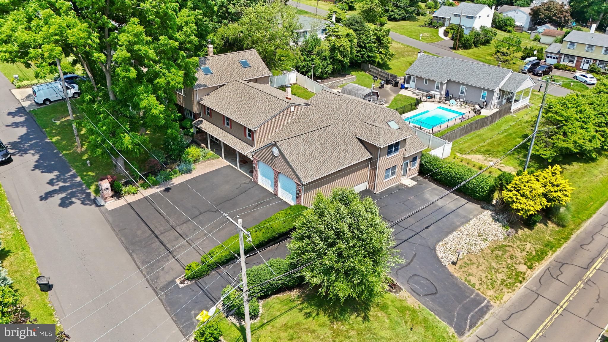 an aerial view of a house with garden space and street view