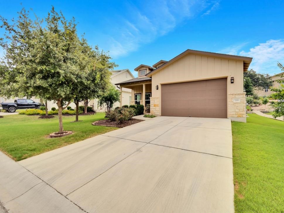 a front view of a house with a yard