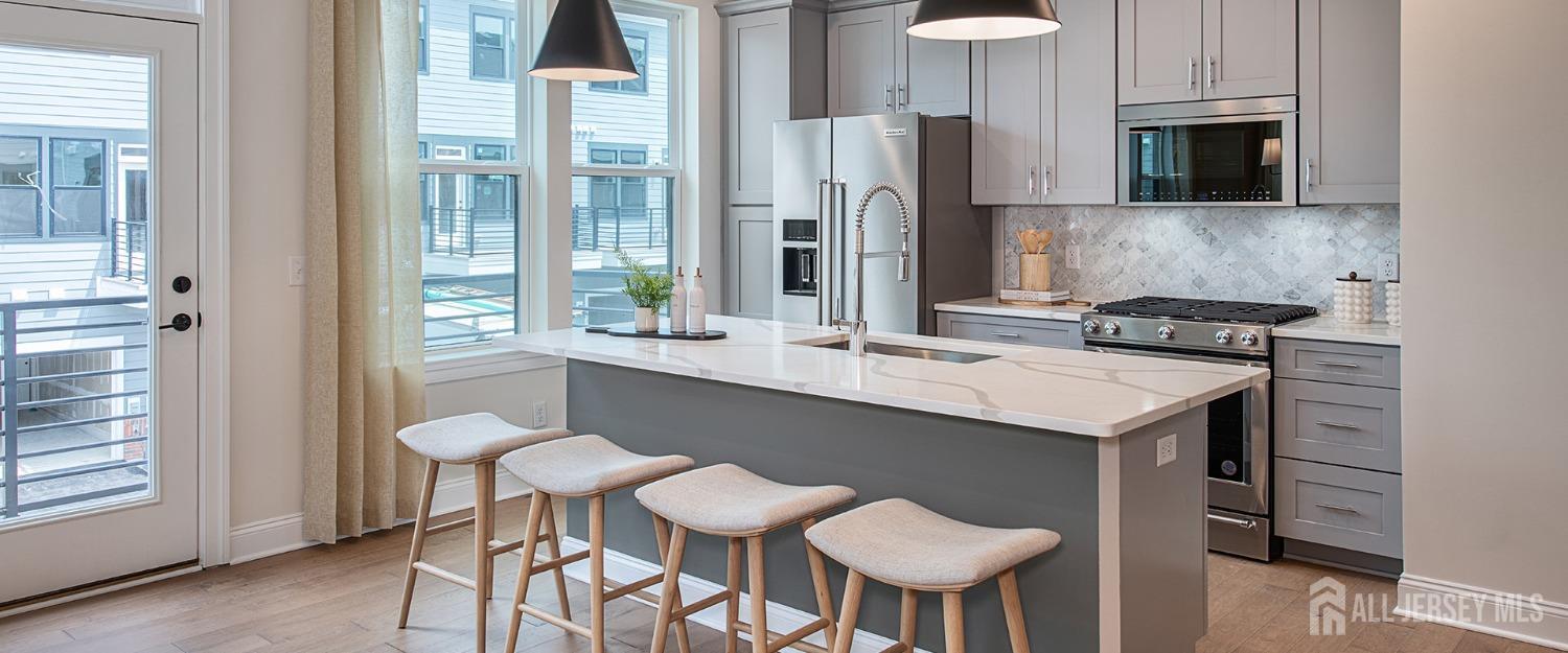 a kitchen with a table chairs refrigerator and cabinets