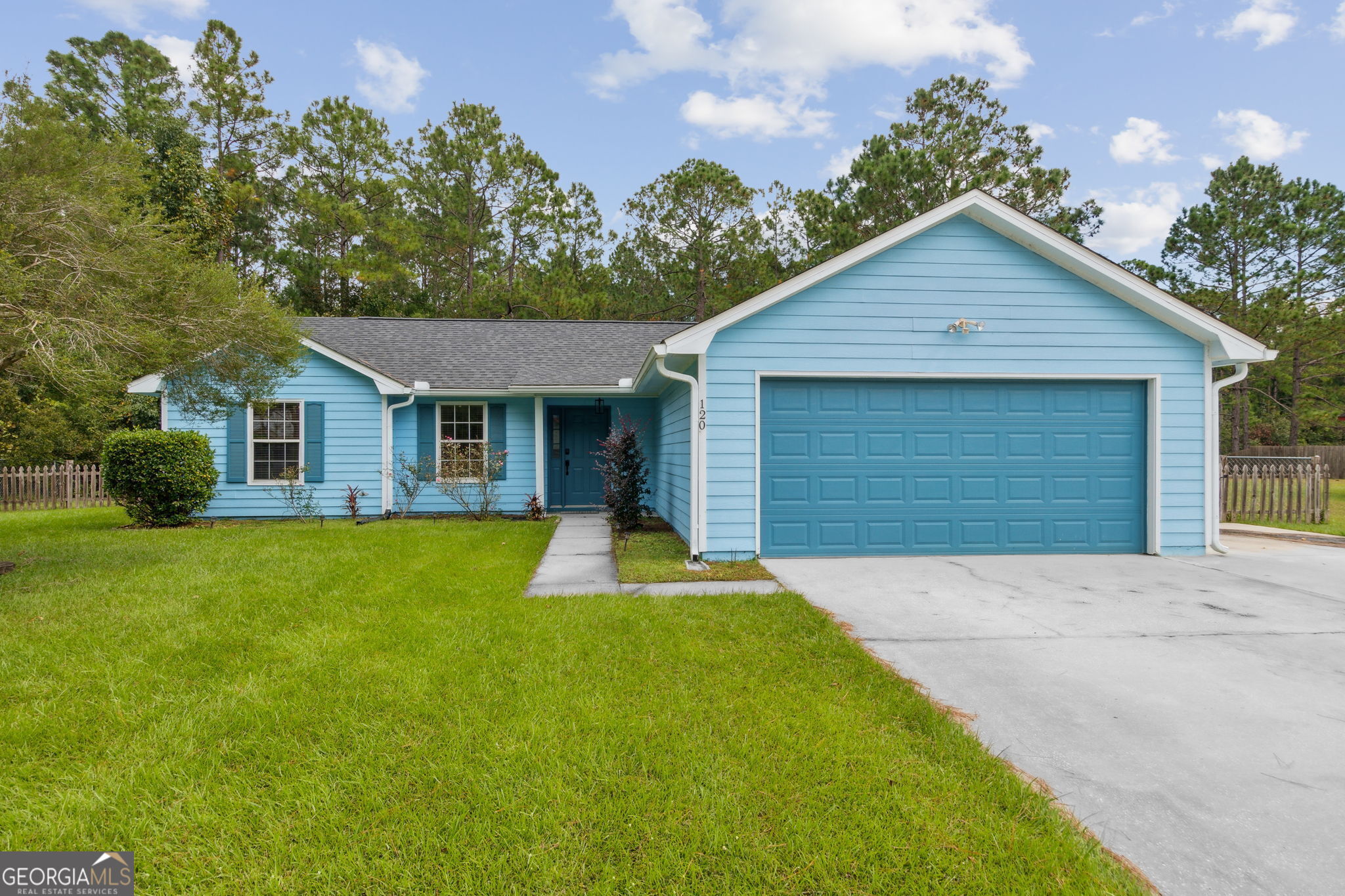 a front view of house with yard and green space