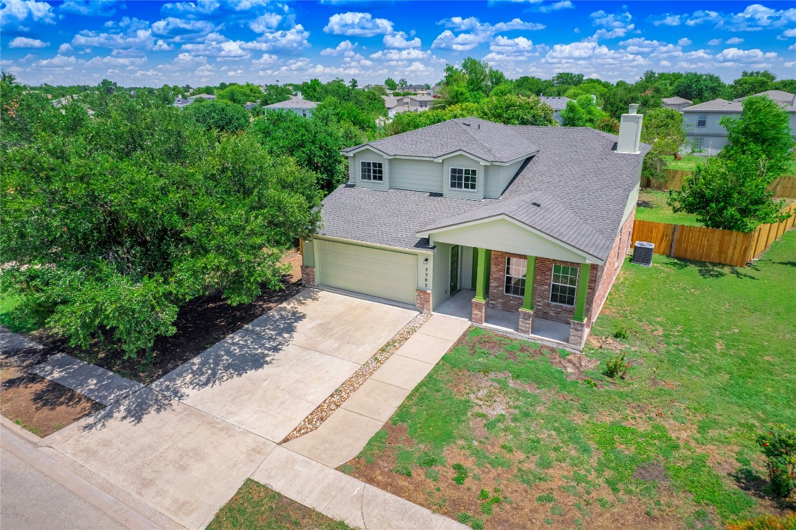 a aerial view of a house with a yard