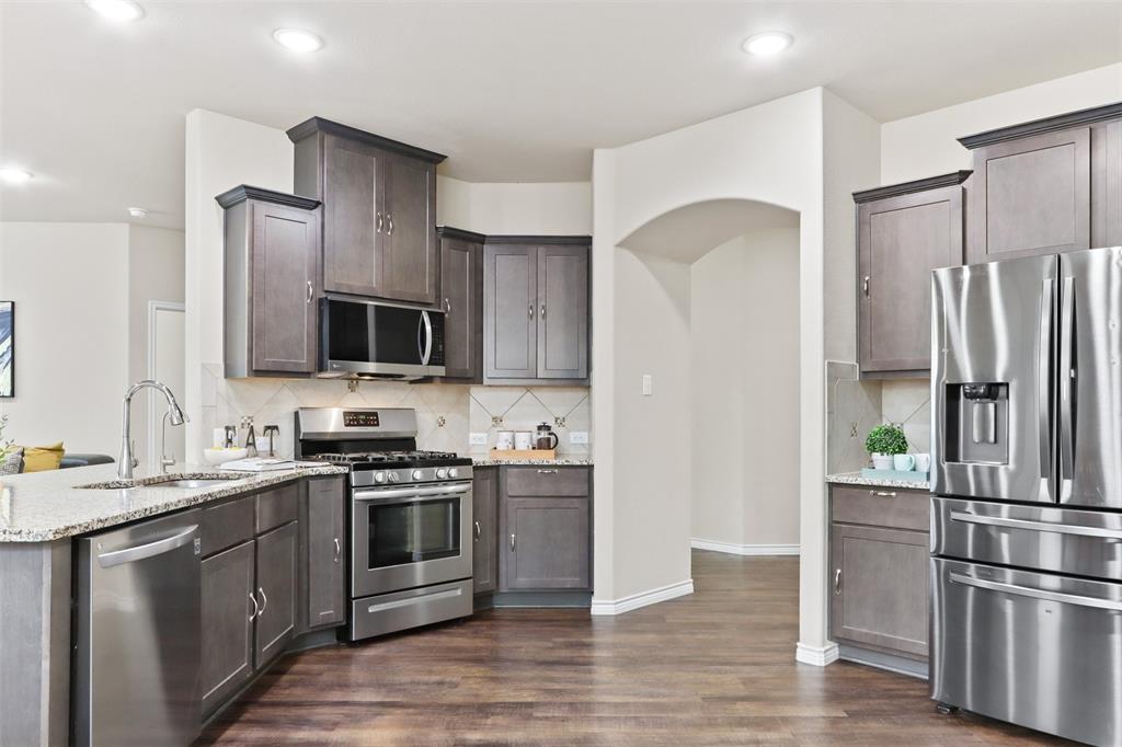 a kitchen with stainless steel appliances a refrigerator stove and microwave