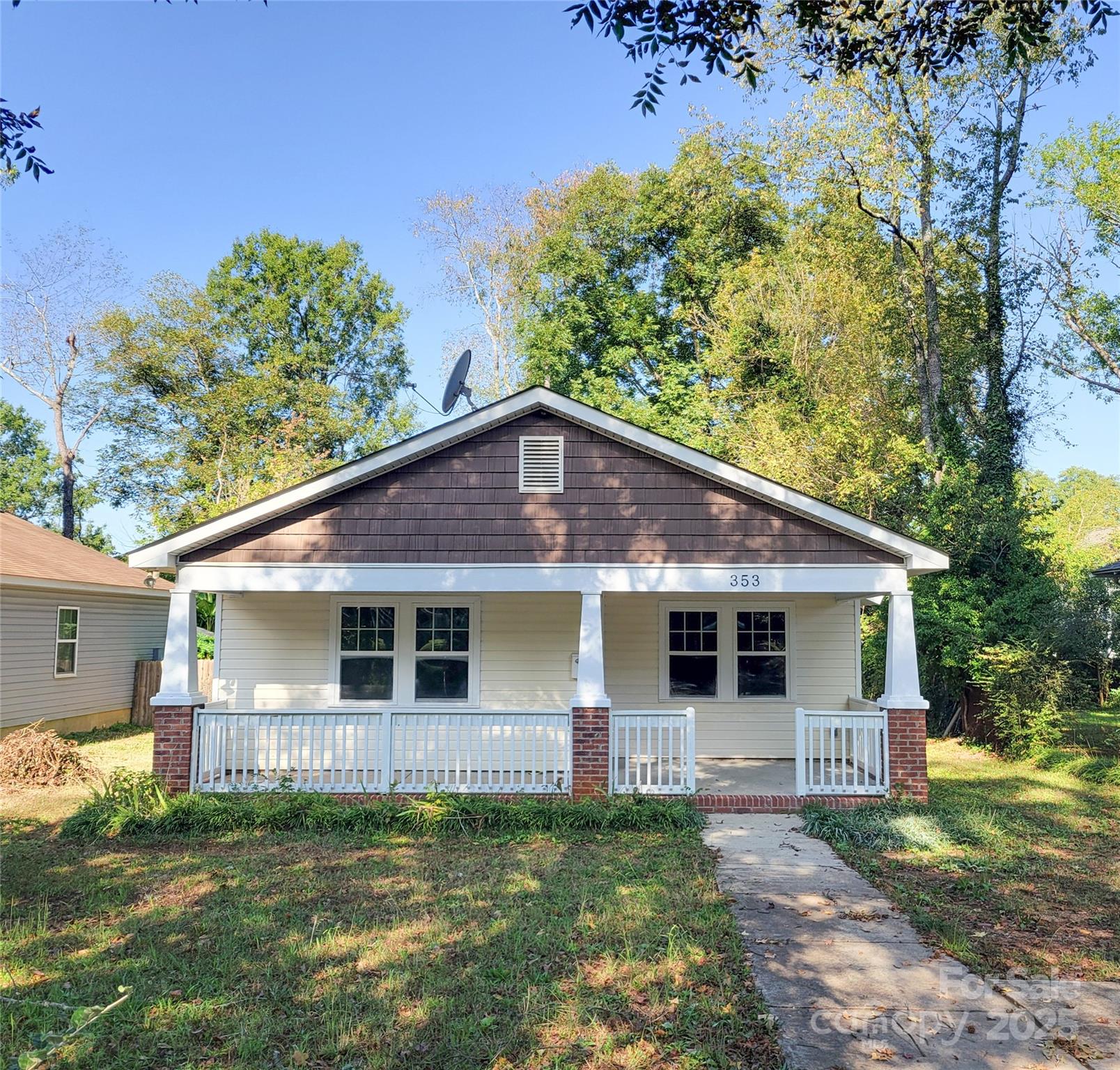 a front view of a house with a garden