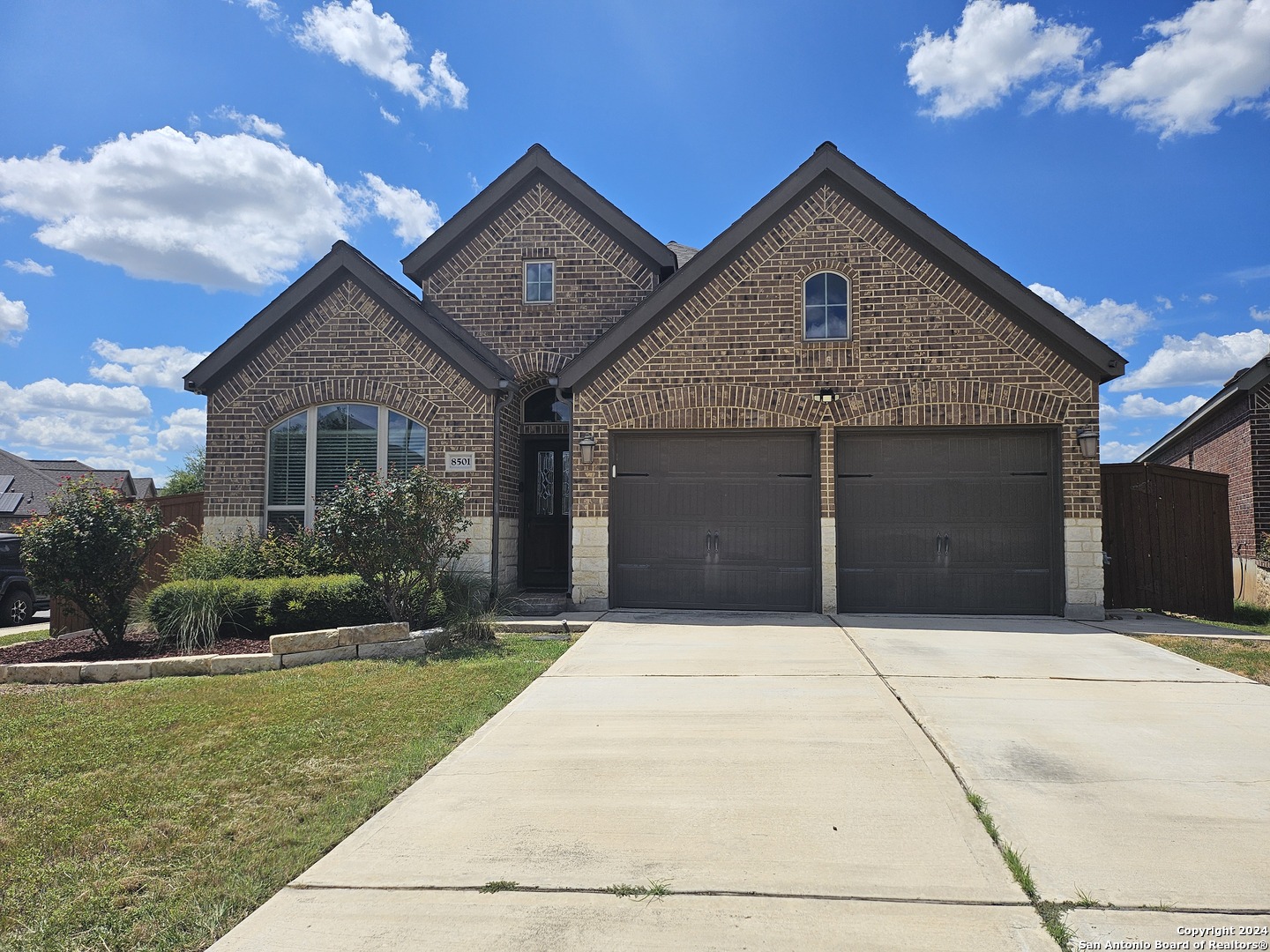 a front view of a house with a yard and garage