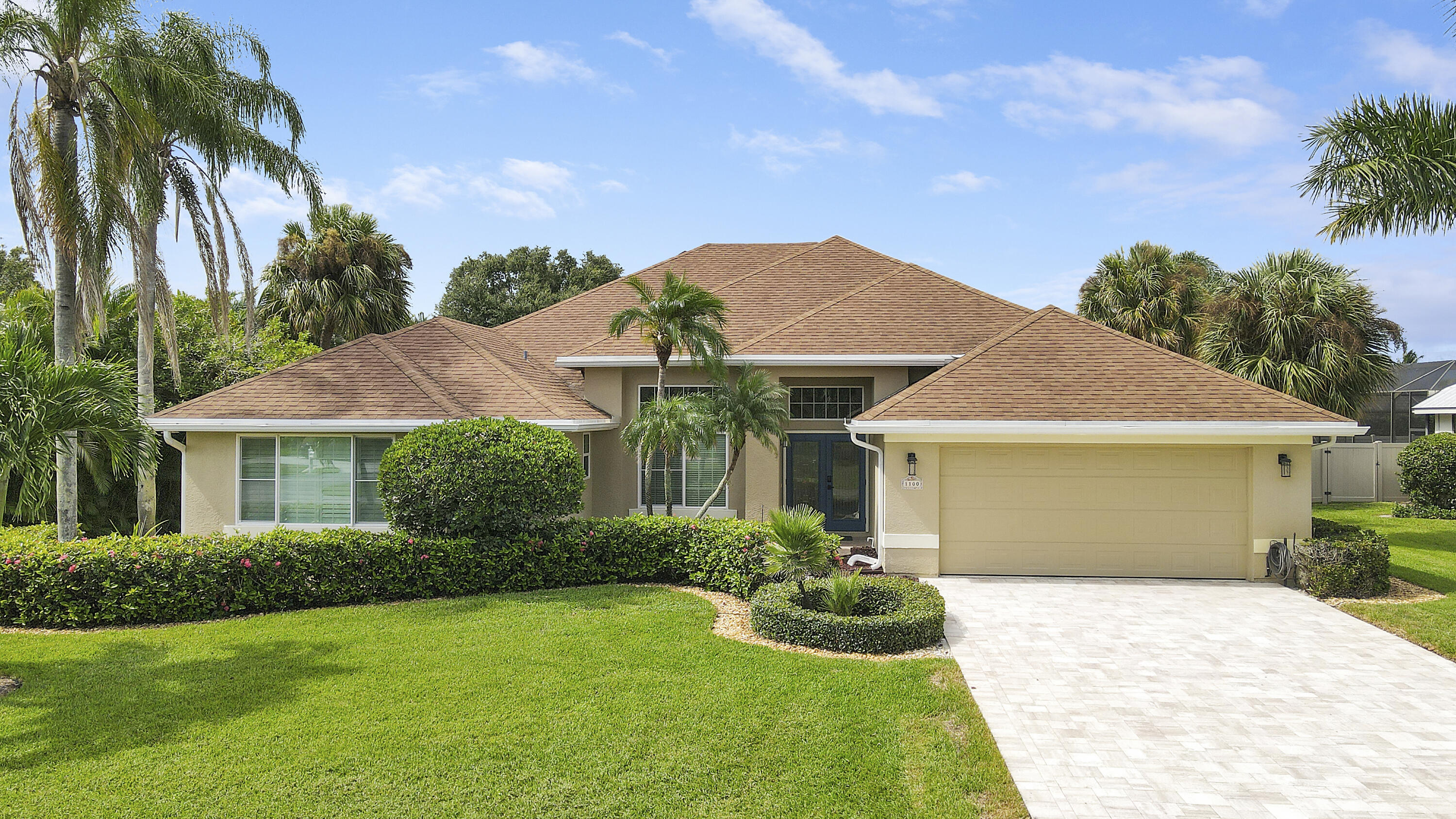 a front view of a house with a garden