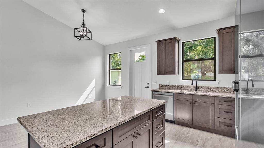 a kitchen with a counter space a sink and cabinets