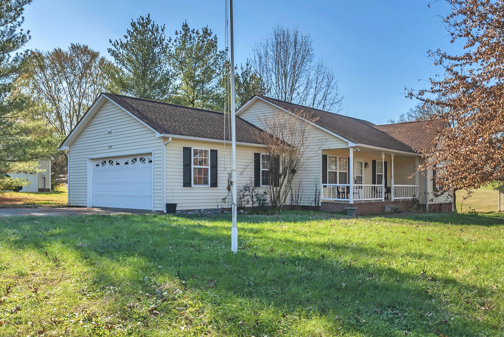 a view of a house with a yard and porch