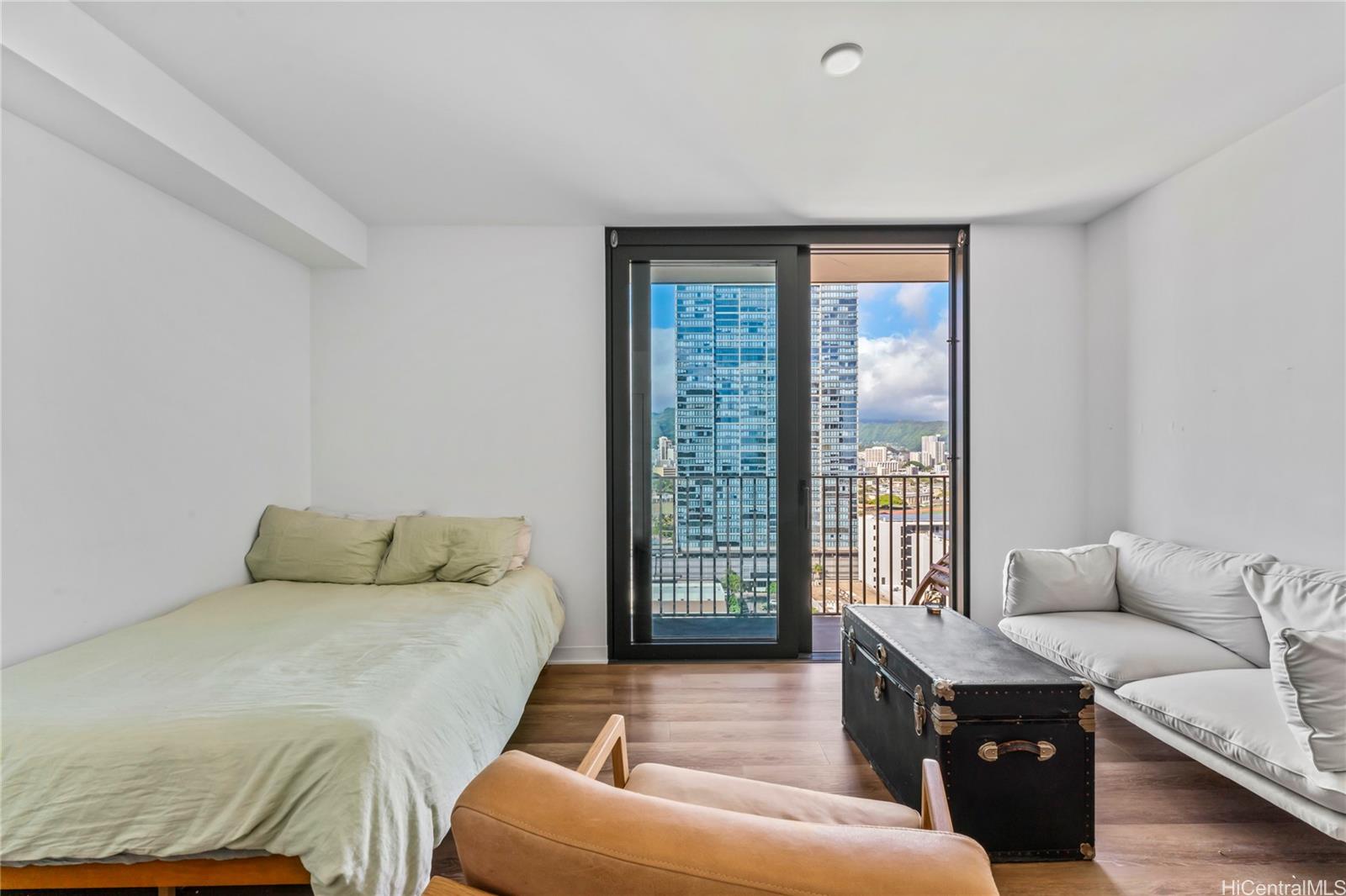 a bedroom with furniture and a large window