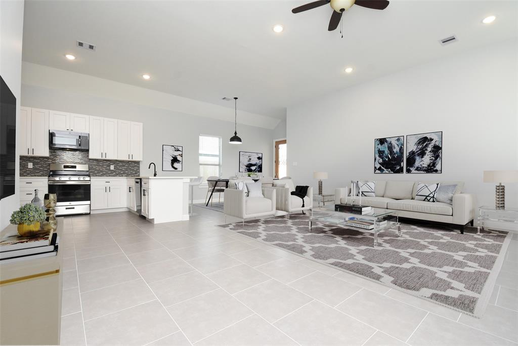 a living room with furniture and kitchen view