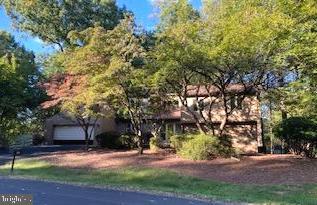 a view of a house with a yard and tree s