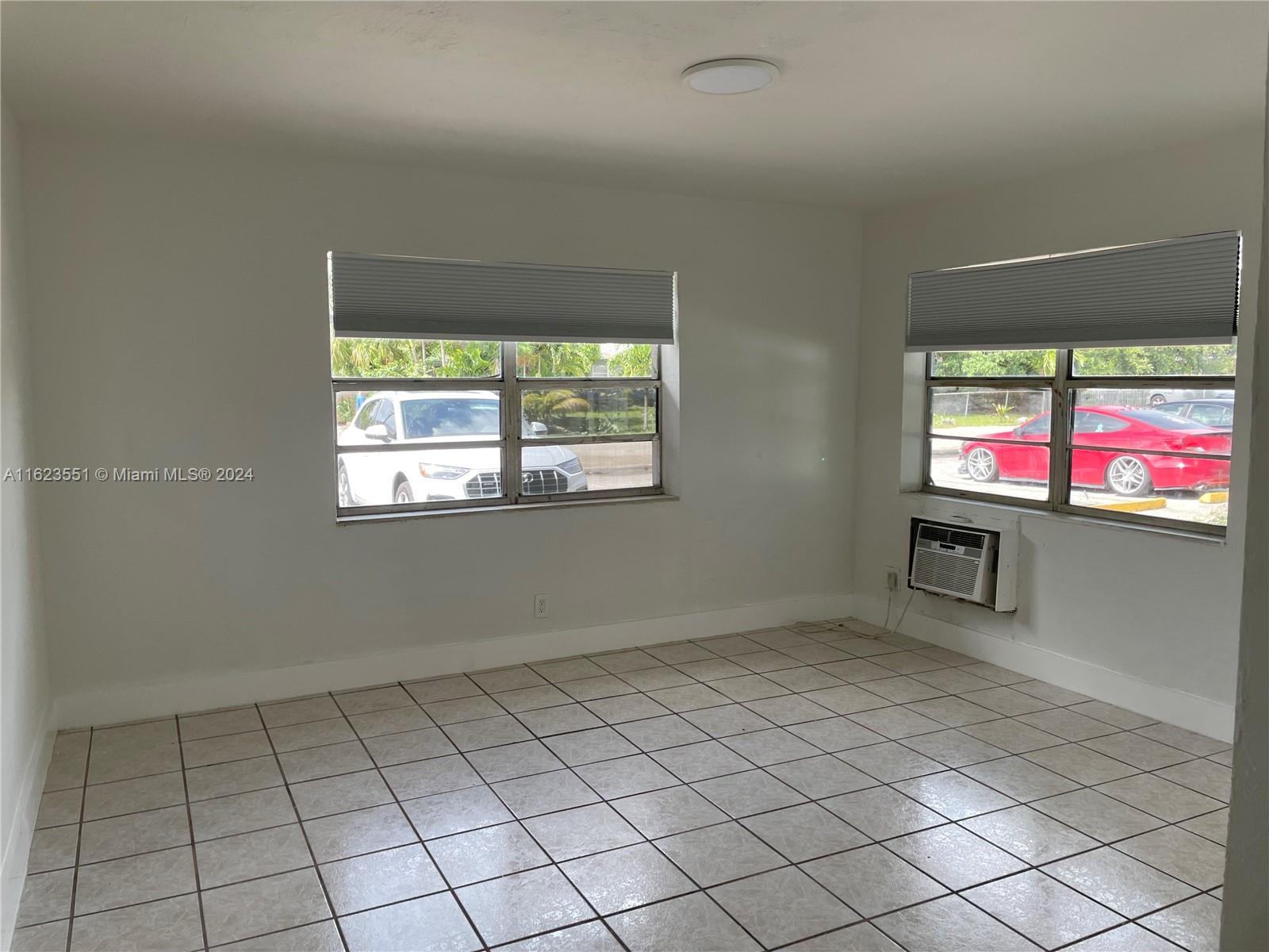 a view of an empty room with a window