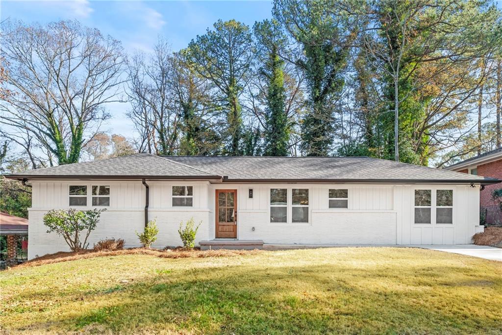 a house that has a big yard with wooden fence