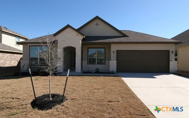 a front view of a house with garage