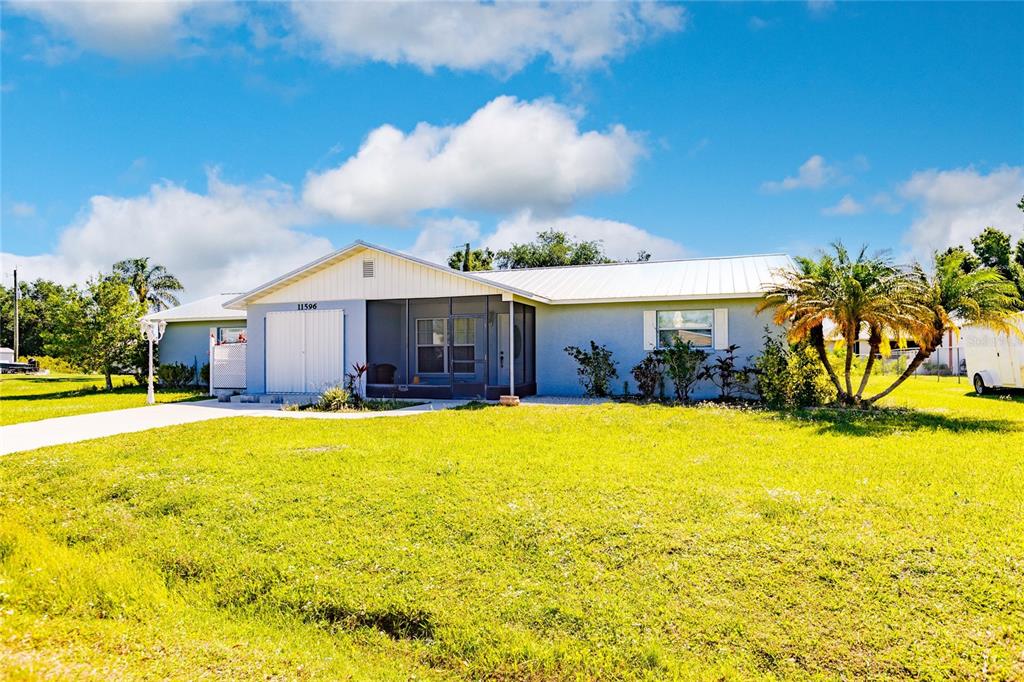 a view of a house with swimming pool and a yard