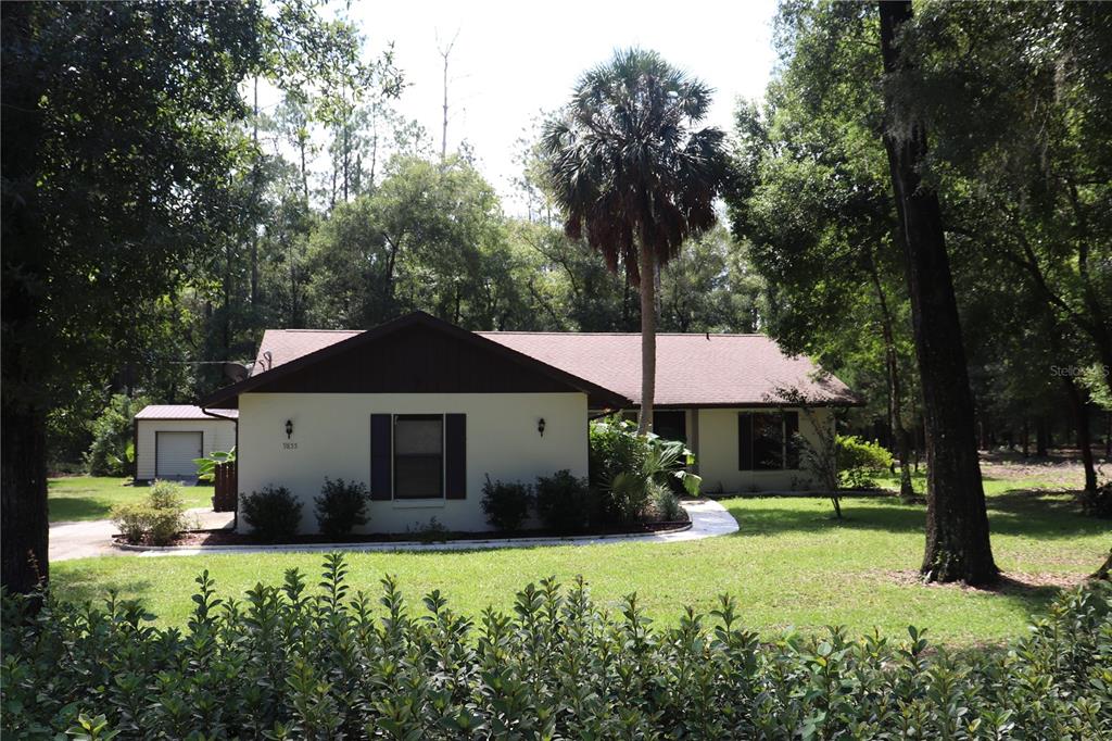 a front view of a house with garden