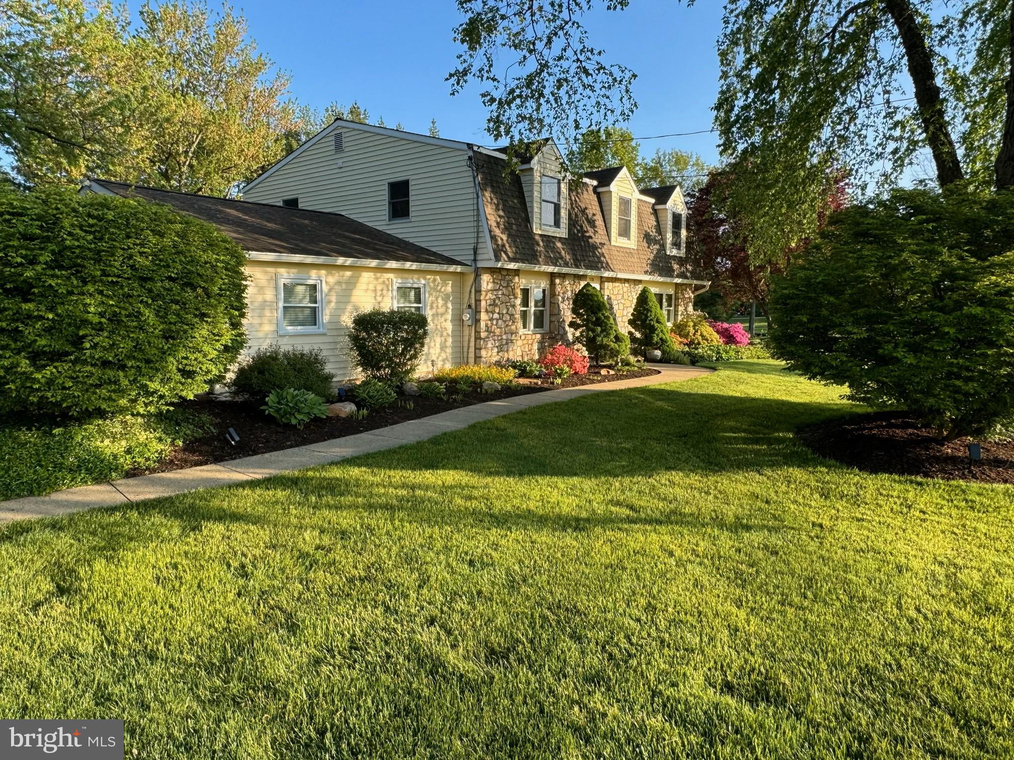 a front view of house with yard and trees