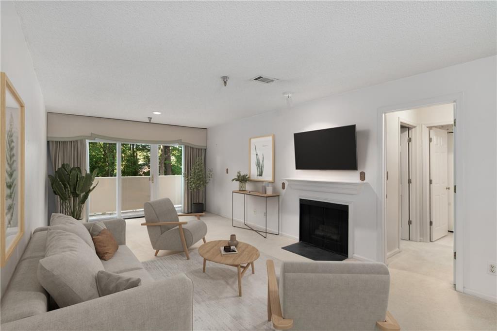 a living room with furniture a fireplace and a flat screen tv