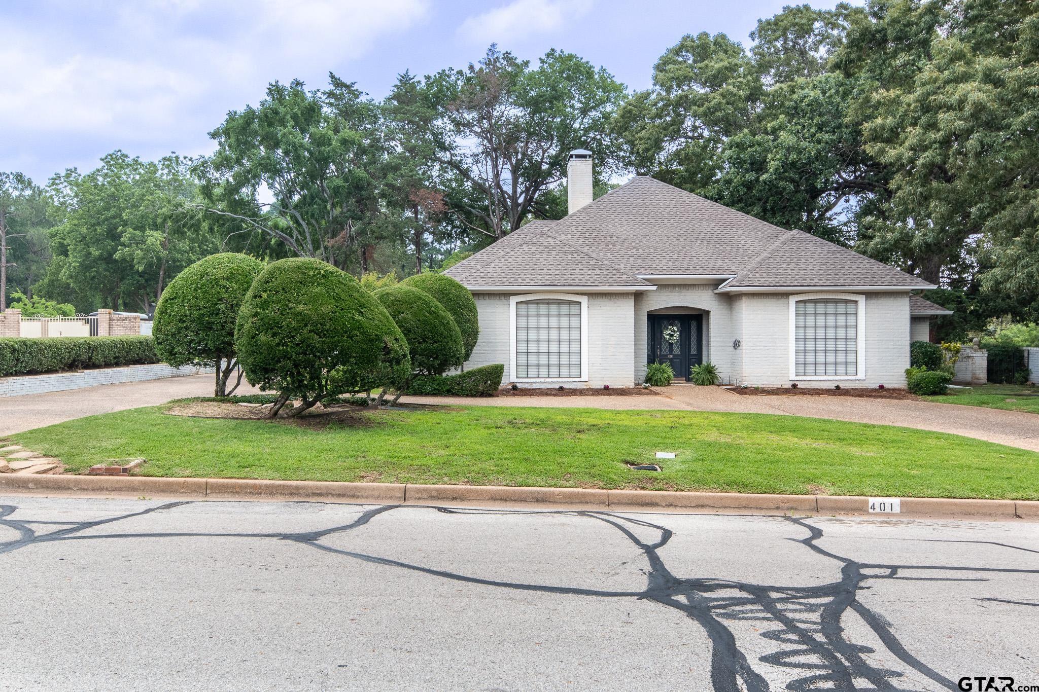 a house that has a tree in front of it