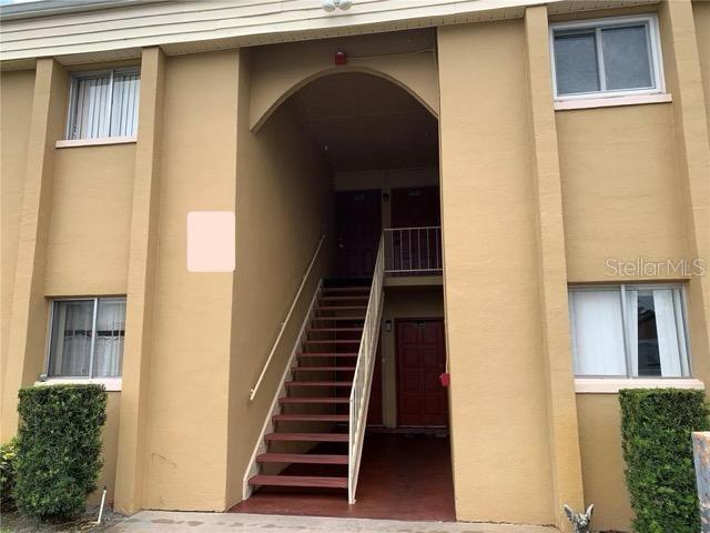 a view of an entryway with wooden floor and stairs