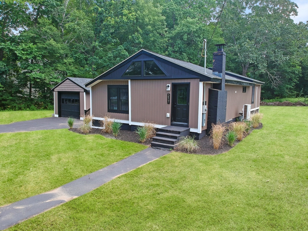 a view of a house with a yard and a garden