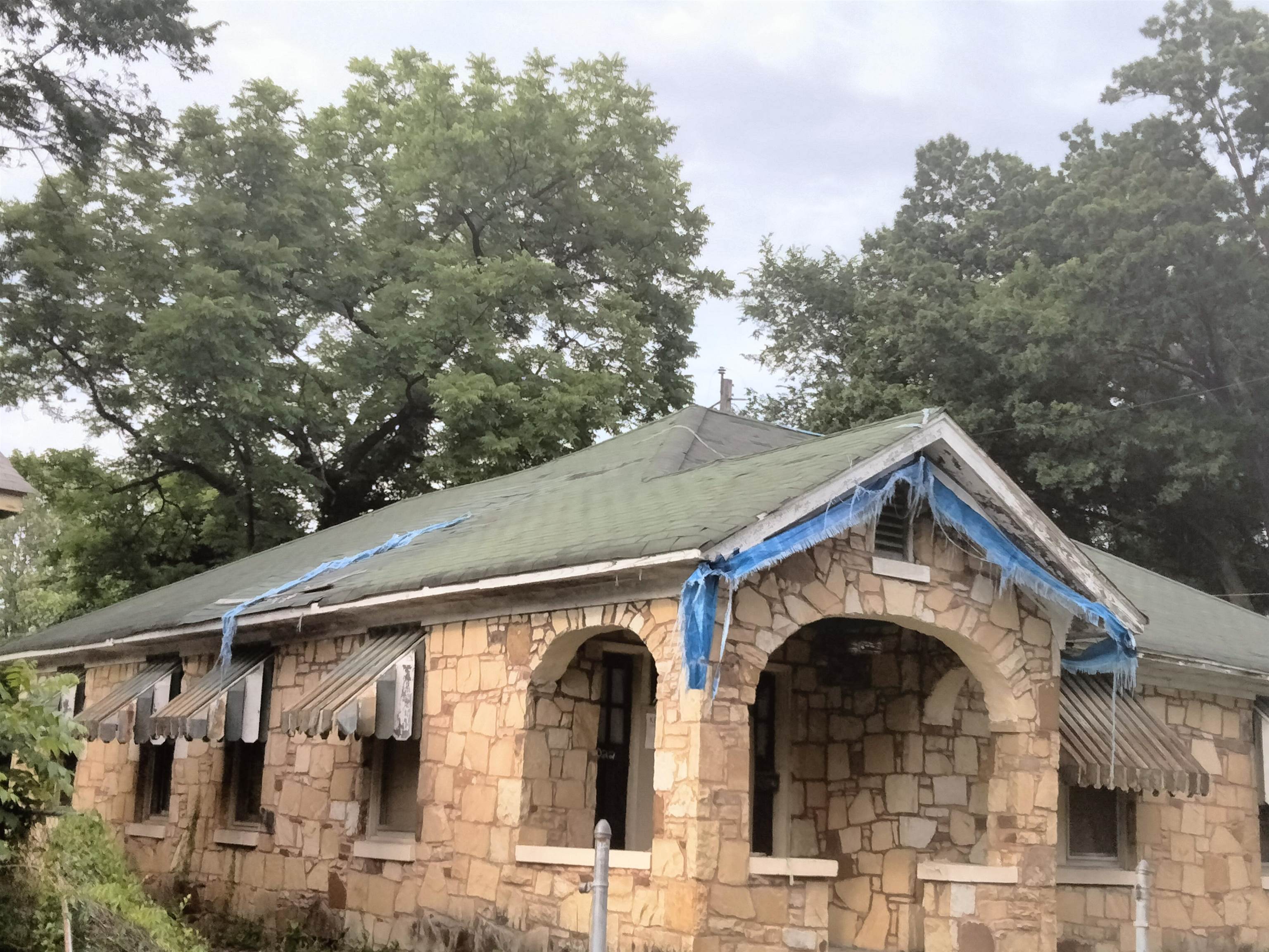 a front view of a house with lots of trees