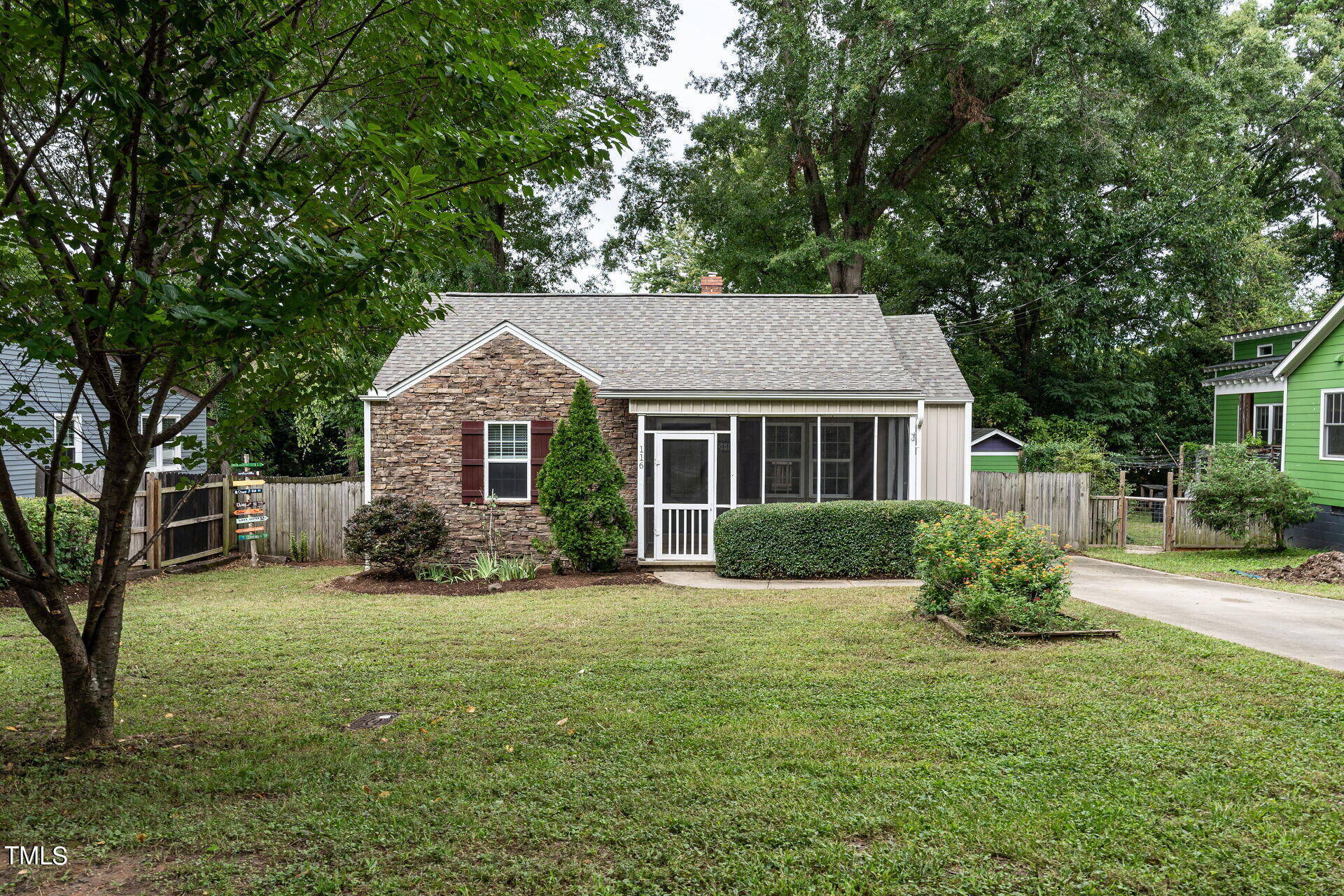 a front view of a house with yard and green space