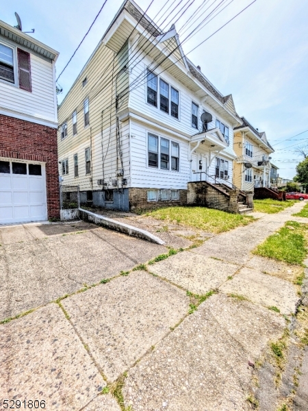 a front view of a building with a yard