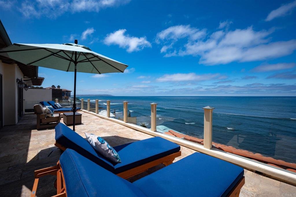 a view of sitting area with furniture and umbrella